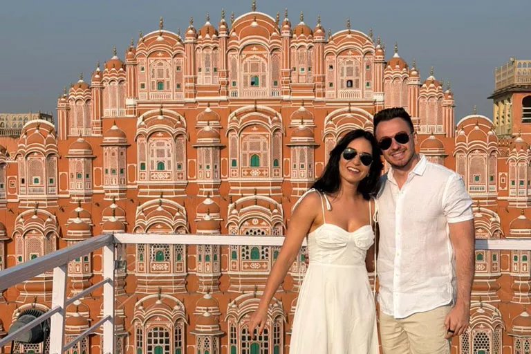 Iconic Hawa Mahal facade glowing pink in the morning light on a private driver tour